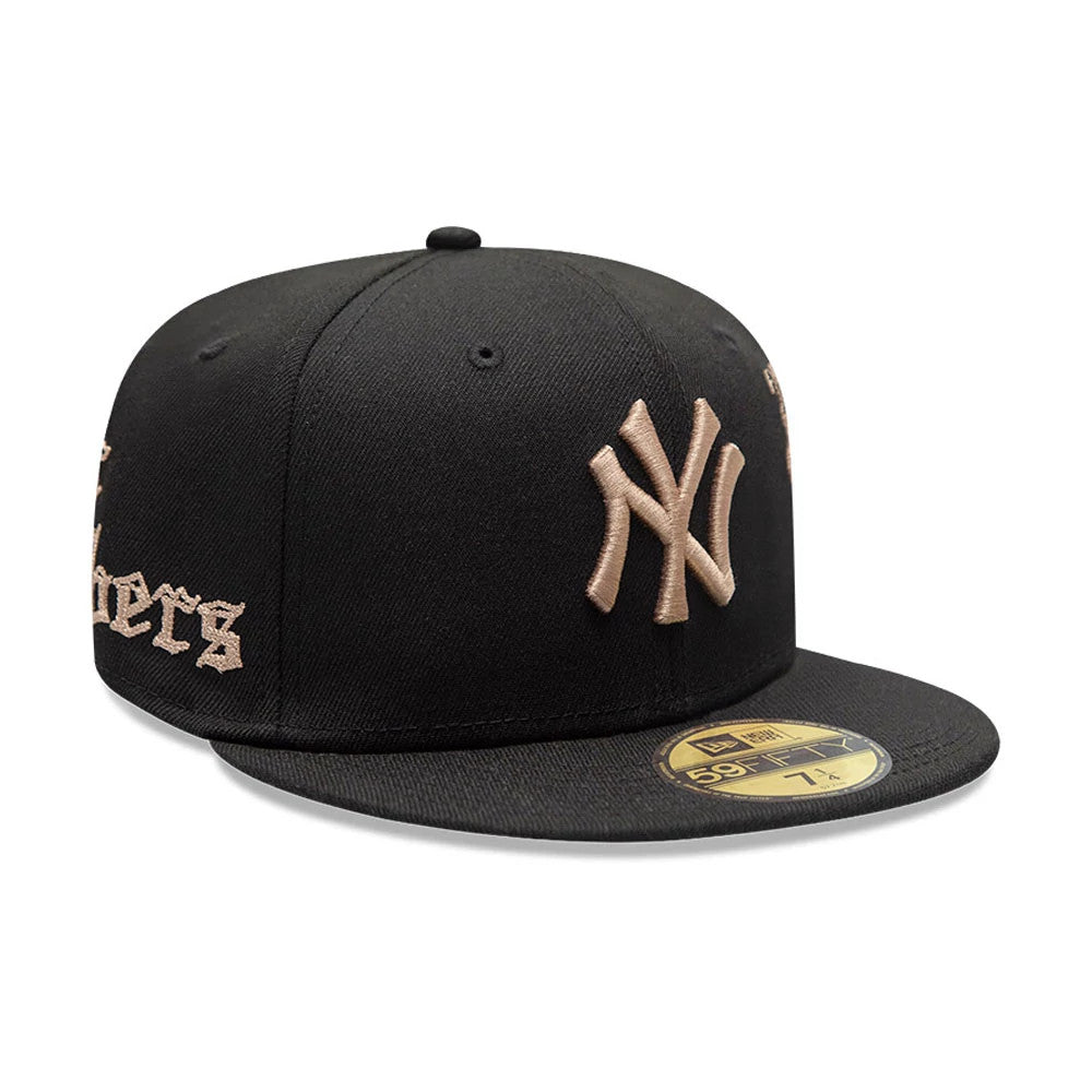 New York Yankees MLB Heritage Black New Era 59FIFTY Fitted Cap, three-quarter view showing the raised gold New York Yankees logo on the front panel, gothic gold lettering on the side, and a gold 59FIFTY size sticker on the flat black visor.