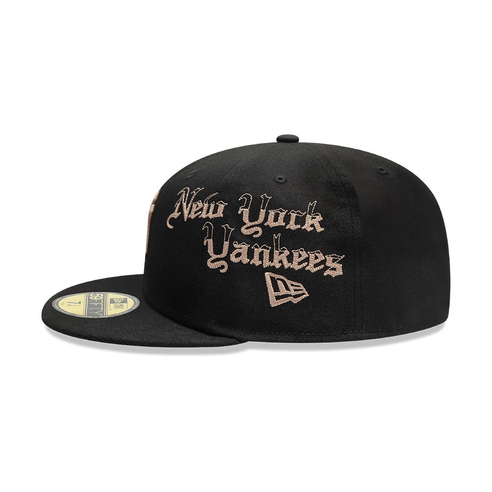 New York Yankees MLB Heritage Black New Era 59FIFTY Fitted Cap, three-quarter view showing raised beige embroidered New York Yankees lettering and New Era flag logo on the front panel, with a flat black visor and gold 59FIFTY size sticker.