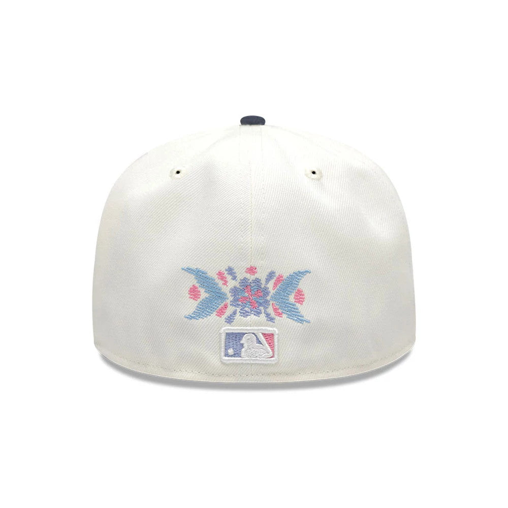 Yankees MLB Day Of The Dead Light Beige & Dark Blue New Era 59FIFTY Fitted Cap, rear view showing a blue and pink embroidered Day of the Dead pattern above the white MLB Batterman logo at the centre of the light beige back panels.