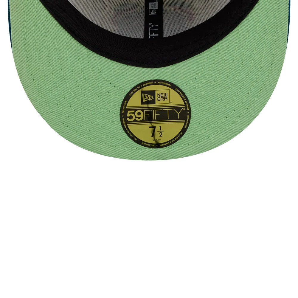 LA Dodgers MLB Day Of The Dead Light Beige & Blue New Era 59FIFTY Fitted Cap, inside view showing a neon green undervisor, a black sweatband lining, and the gold 59FIFTY size sticker at the centre near the opening.