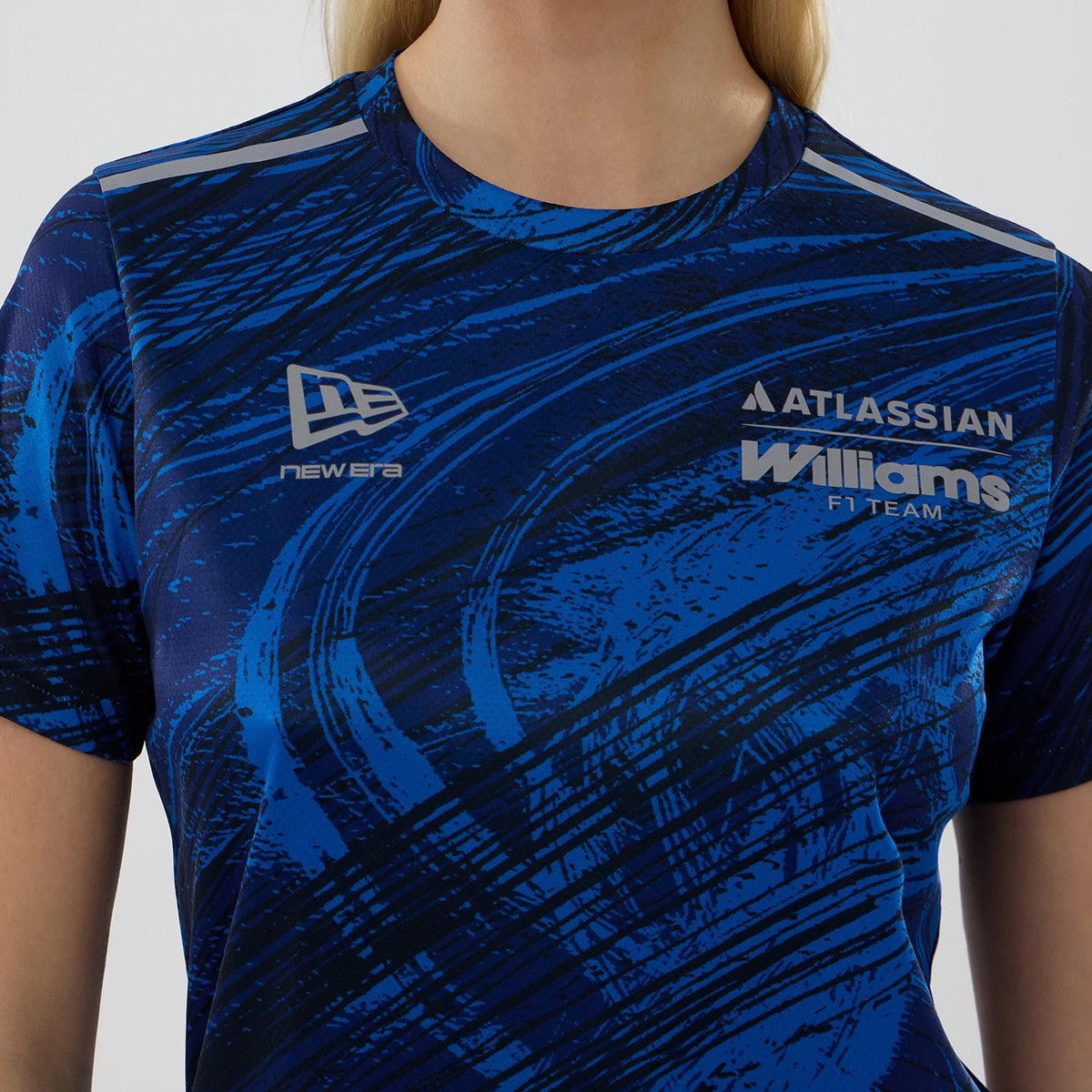 New Era Williams Womens Navy Active T-Shirt, front view showing a blue and black graphic pattern, an embroidered New Era logo on the upper chest, and embroidered Atlassian Williams F1 Team branding on the right side, worn by a model.
