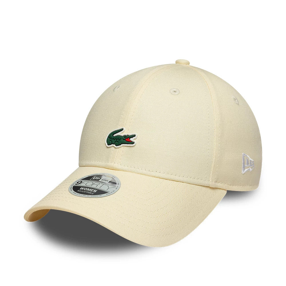Womens Lacoste X New Era Light Beige 9FORTY Adjustable Cap, three-quarter view showing the green and red Lacoste crocodile logo on the structured front panel, white New Era flag logo on the left side and 9FORTY size sticker on the curved visor.