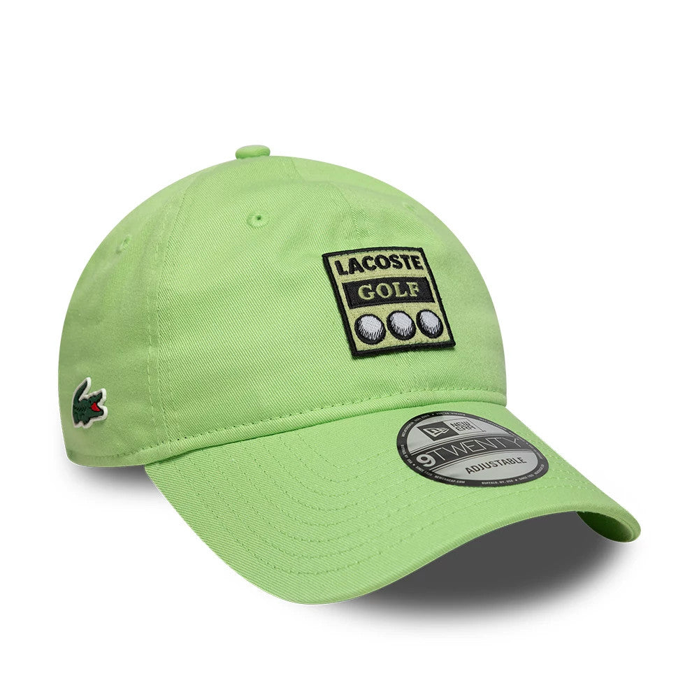 Lacoste X New Era Pastel Green 9TWENTY Adjustable Cap, front view showing the black and white embroidered Lacoste Golf logo on the front panel, a 9TWENTY size sticker on the curved visor, and the green crocodile logo on the left side.