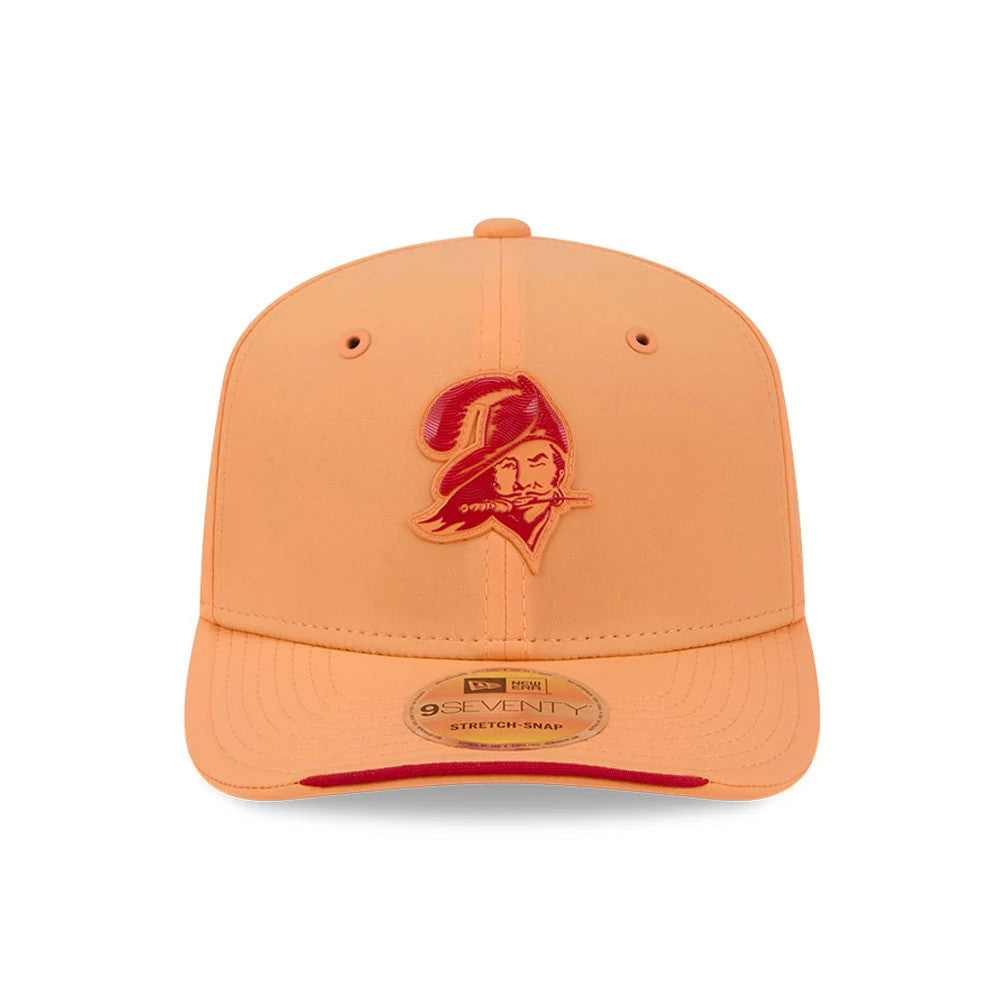 Buccaneers NFL Sideline 2026 Orange New Era 9SEVENTY Stretch Snap Adjustable Cap, front view showing a raised red Buccaneers logo embroidered on the front panel, orange visor with a 9SEVENTY size sticker, and matching orange eyelets and top button.