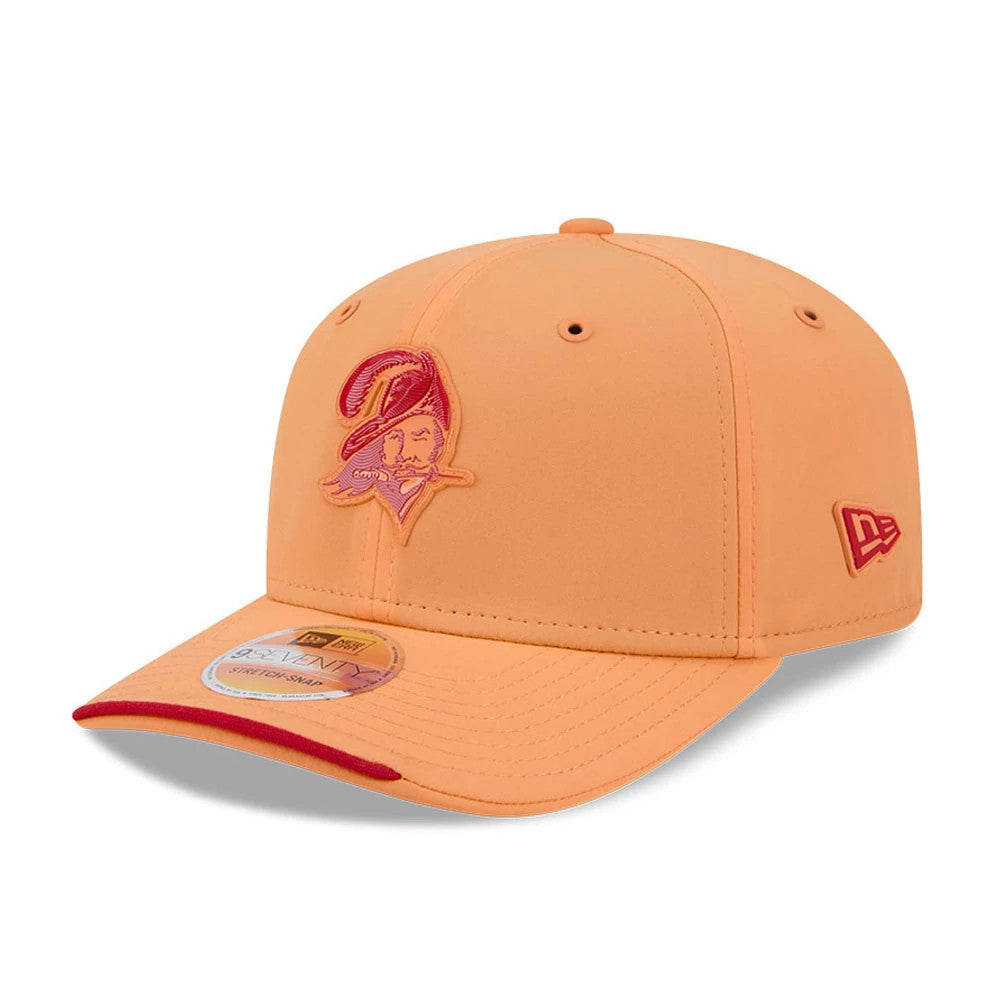 Buccaneers NFL Sideline 2026 Orange New Era 9SEVENTY Stretch Snap Adjustable Cap, front view showing a raised red Buccaneers logo on the orange front panel, with a red New Era flag logo on the left side and a 9SEVENTY size sticker on the visor.