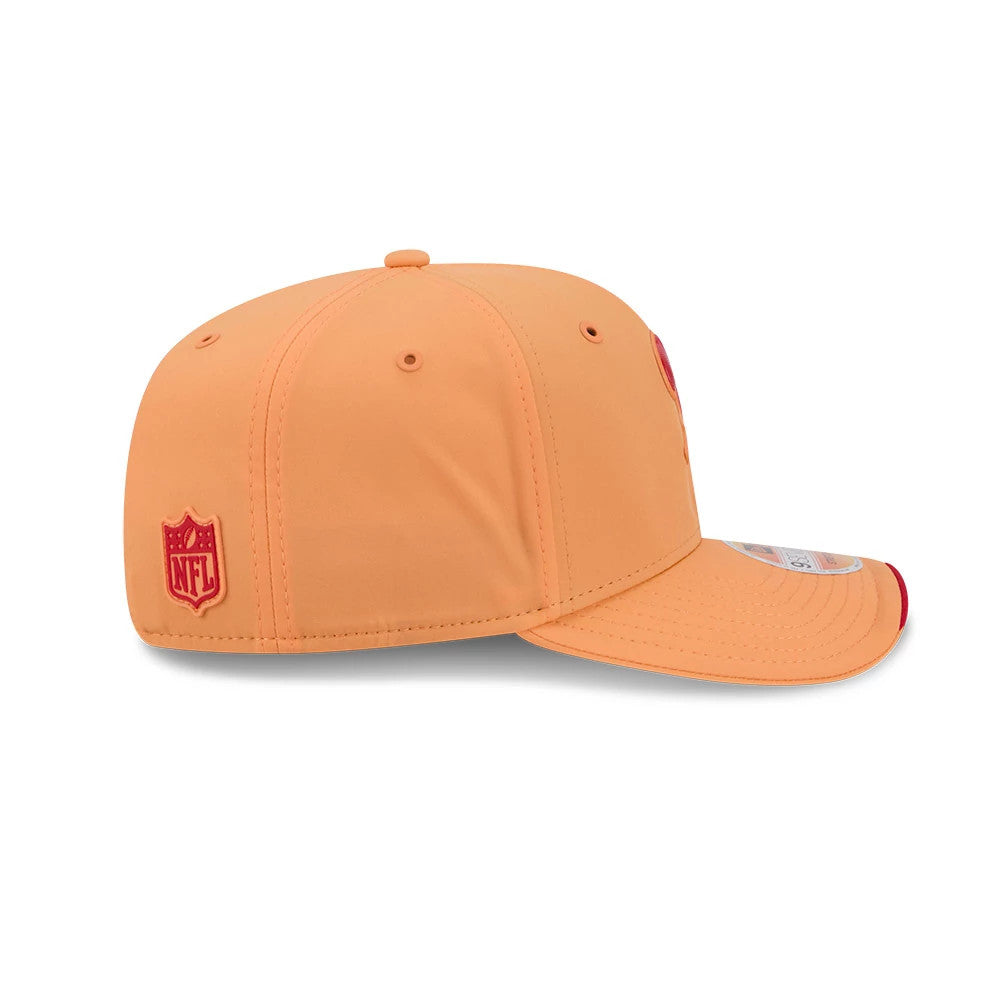 Buccaneers NFL Sideline 2026 Orange New Era 9SEVENTY Stretch Snap Adjustable Cap, side view showing the red embroidered NFL logo on the structured orange crown, curved visor with a red edge, and a 9SEVENTY size sticker on the right side.