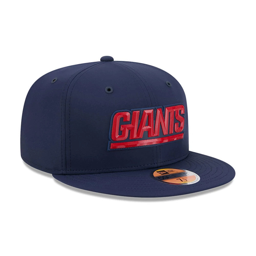 New York Giants NFL Sideline 2026 Dark Blue New Era 59FIFTY Fitted Cap, front view showing raised red embroidered GIANTS lettering on the structured dark blue crown, with matching flat visor and gold 59FIFTY size sticker on the visor.