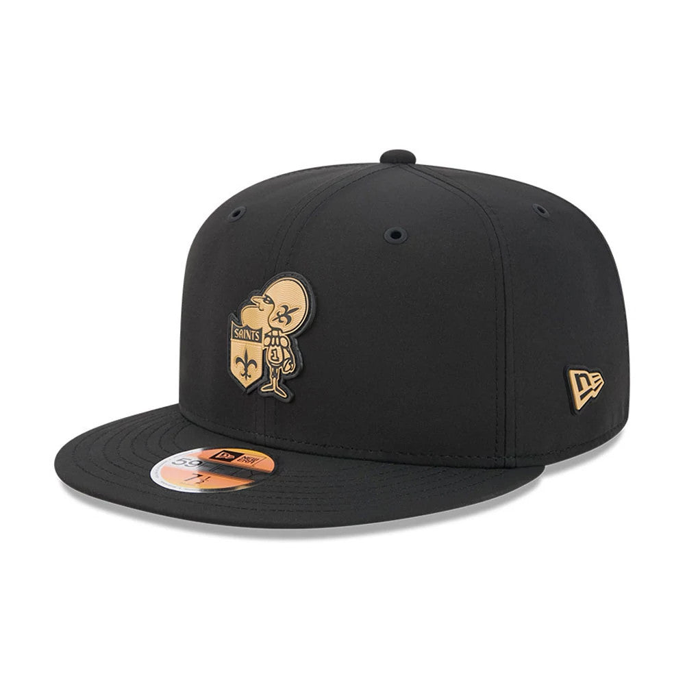 New Orleans Saints NFL Sideline 2026 Black New Era 59FIFTY Fitted Cap, three-quarter view showing the gold and black embroidered Saints mascot logo on the front panel, flat black visor with 59FIFTY size sticker.