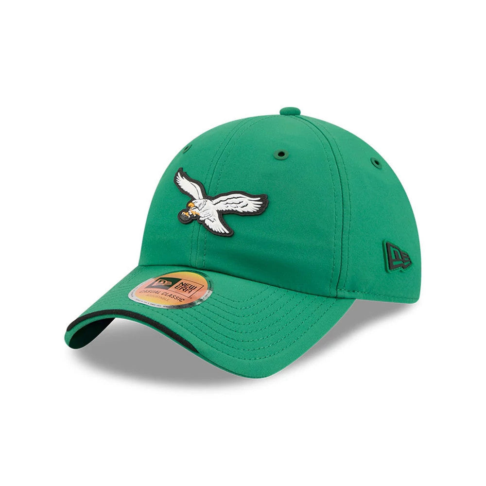 New Era Philadelphia Eagles NFL Sideline 2026 Green Casual Classic Adjustable Cap, three-quarter view showing the white and black embroidered eagle logo on the front panel, green curved visor with a gold adjustable cap size sticker.