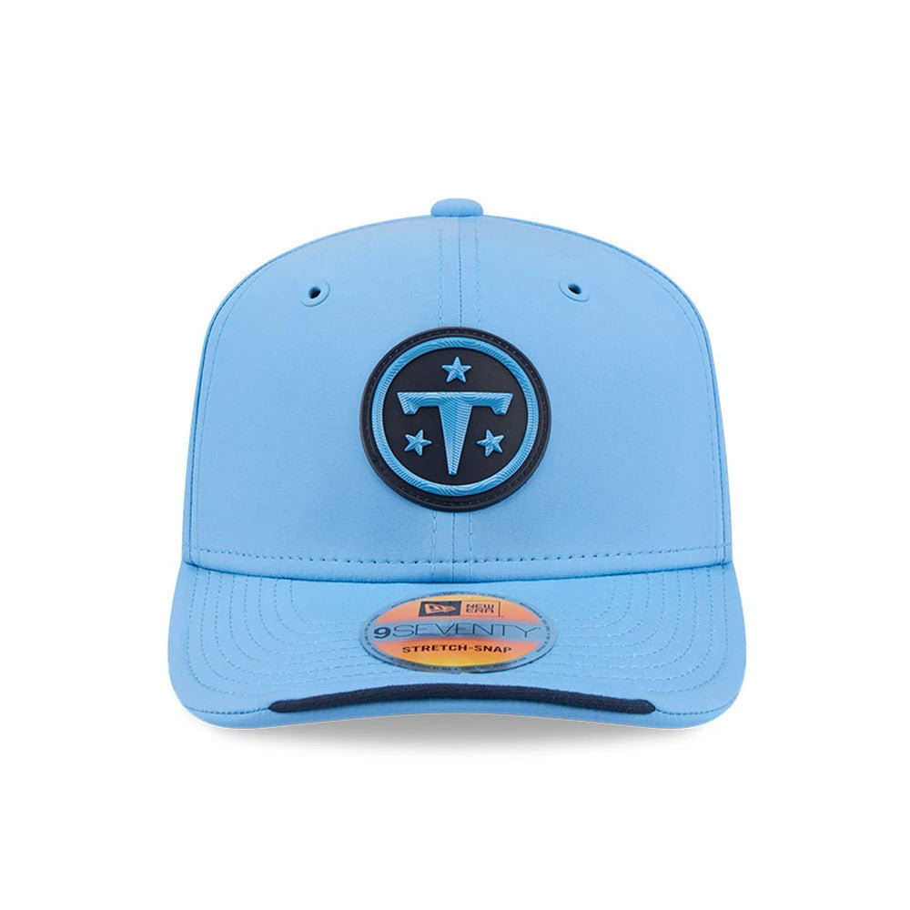 Titans NFL Sideline 2026 Pastel Blue New Era 9SEVENTY Stretch Snap Adjustable Cap, front view showing the large black and blue Titans logo embroidered on the structured pastel blue crown, with a 9SEVENTY size sticker on the matching visor.