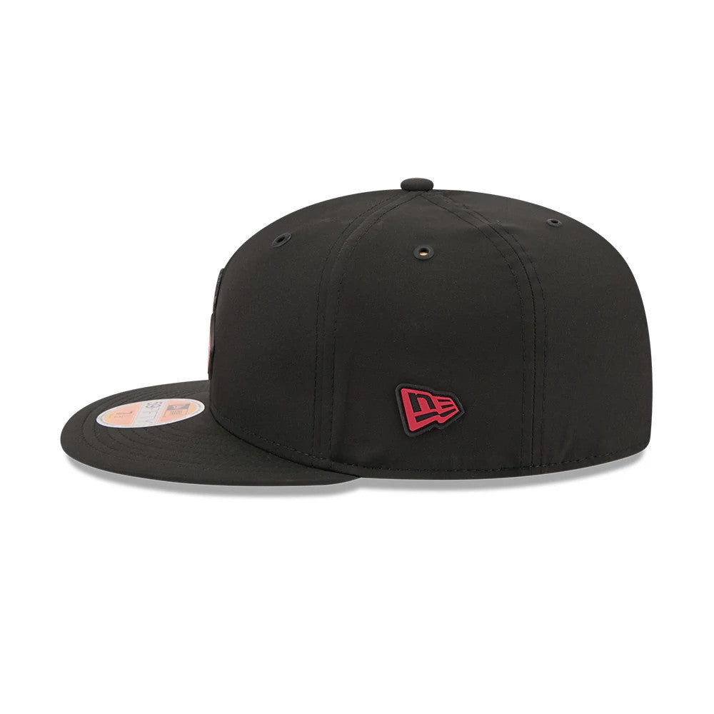 Arizona Cardinals NFL Sideline 2026 Black New Era 59FIFTY Fitted Cap, side view showing the red embroidered New Era flag logo on the left side, with a structured black crown, black flat visor, and 59FIFTY size sticker on the visor.