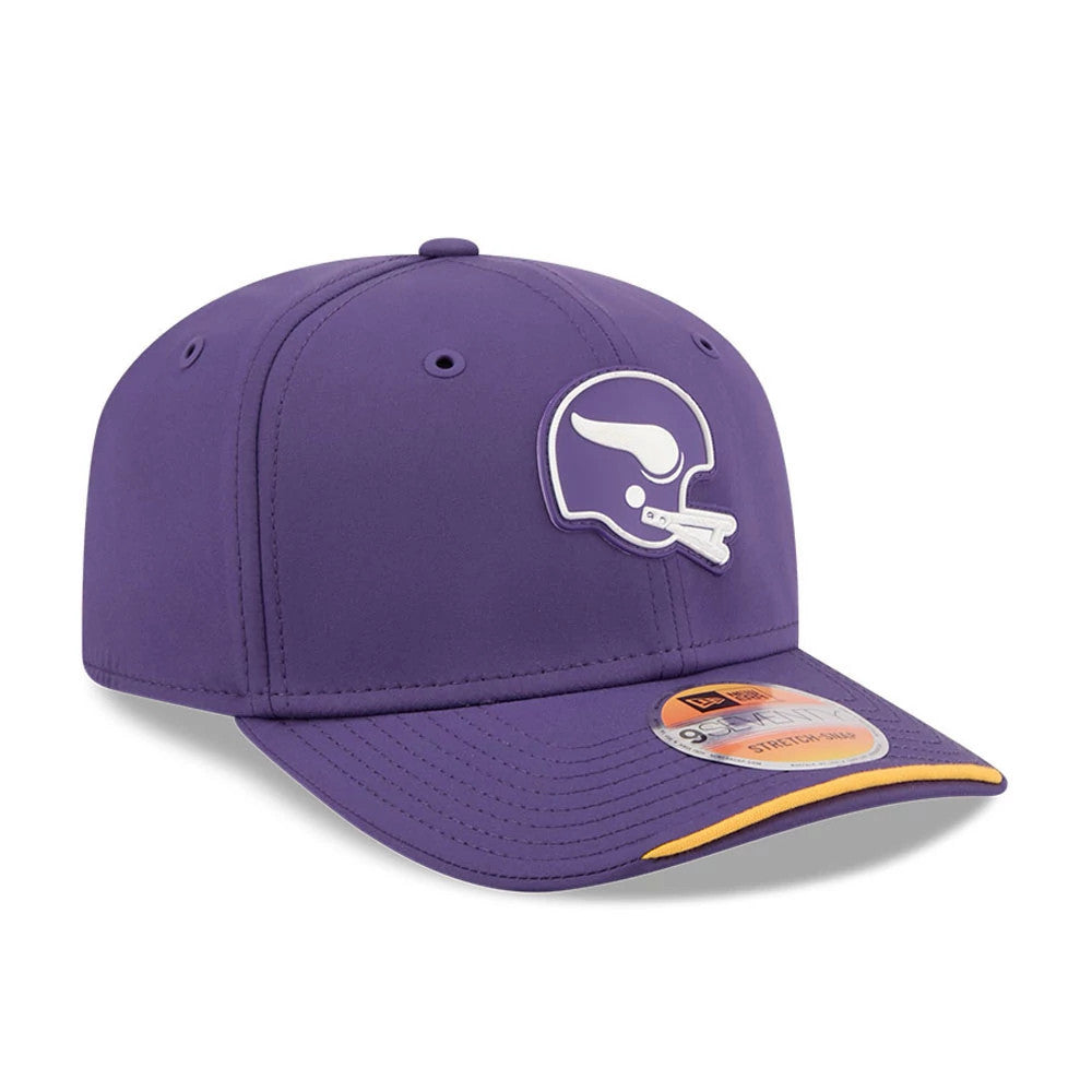 Vikings NFL Sideline 2026 Purple New Era 9SEVENTY Stretch Snap Adjustable Cap, three-quarter view showing the raised white and purple helmet logo embroidered on the front panel, a curved visor with an orange accent, and a 9SEVENTY size sticker.