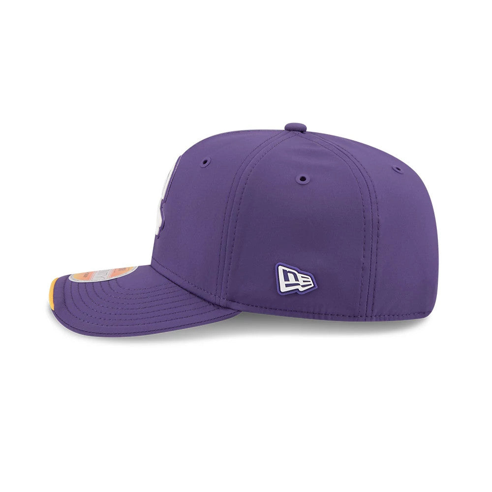 Vikings NFL Sideline 2026 Purple New Era 9SEVENTY Stretch Snap Adjustable Cap, side view showing the white New Era flag logo on the left side, a structured purple crown with embroidered eyelets, and an orange size sticker on the purple curved visor.