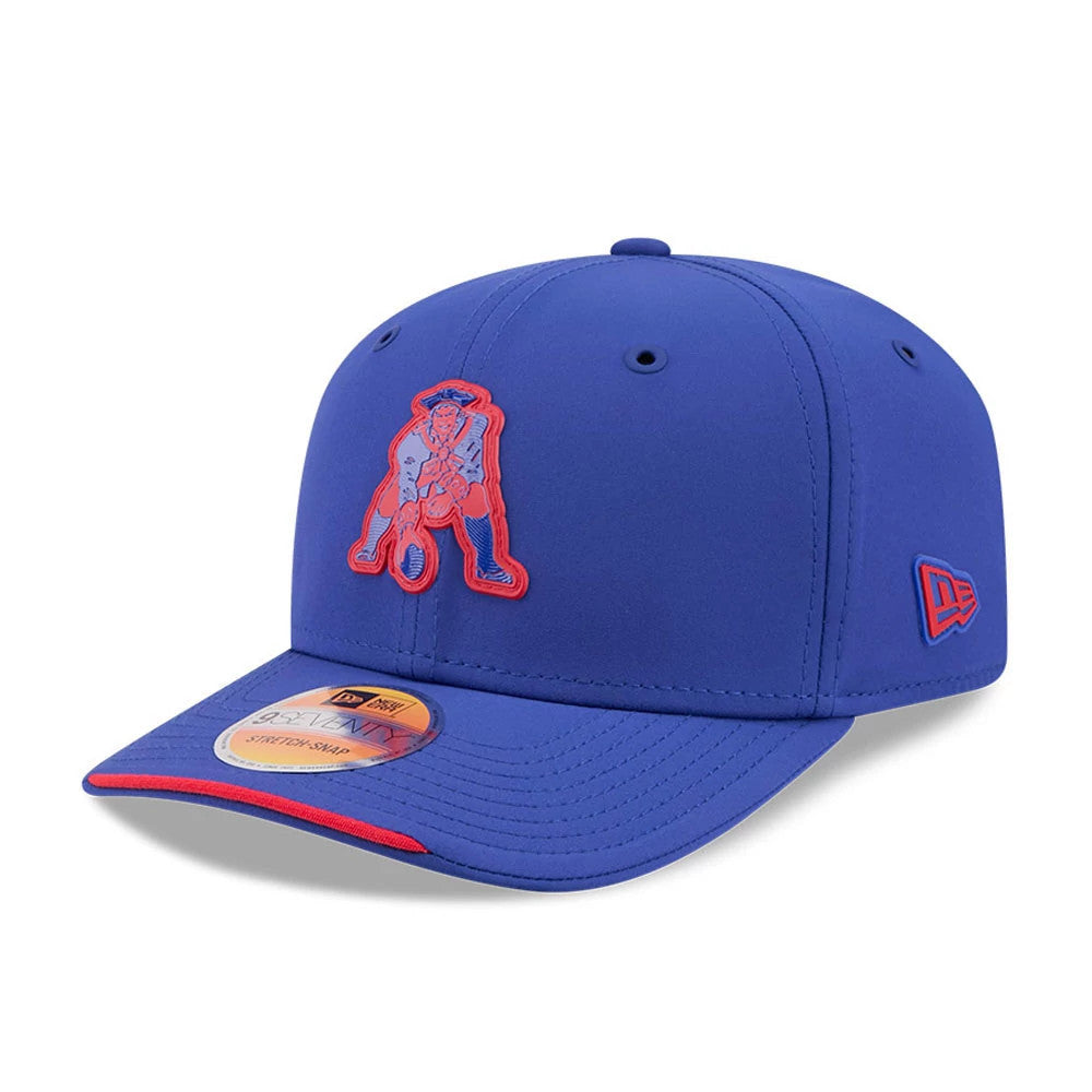 Patriots NFL Sideline 2026 Blue New Era 9SEVENTY Stretch Snap Adjustable Cap, three-quarter view showing the red embroidered Patriots logo on the front panel, blue visor with a red edge detail, and New Era flag logo on the left side.