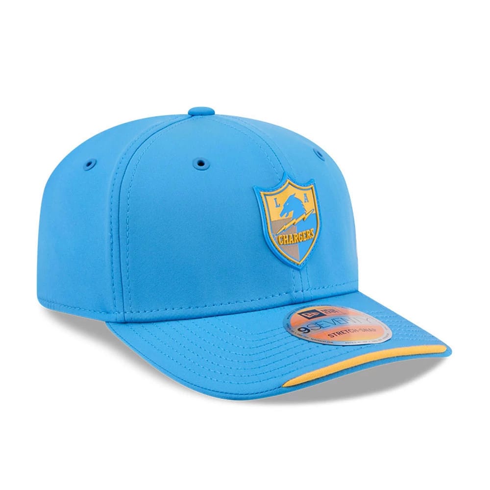 LA Chargers NFL Sideline 2026 Blue New Era 9SEVENTY Stretch Snap Adjustable Cap, three-quarter view showing the raised gold and blue team logo on the front panel, with a curved blue visor featuring a 9SEVENTY size sticker and a yellow edge accent.