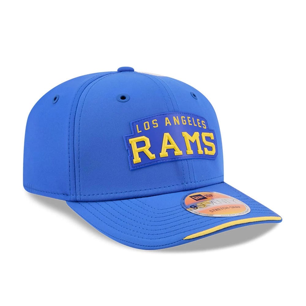 LA Rams NFL Sideline 2026 Blue New Era 9SEVENTY Stretch Snap Adjustable Cap, front view showing a raised yellow embroidered Rams logo on the blue front panel, complemented by a curved visor with a 9SEVENTY size sticker.