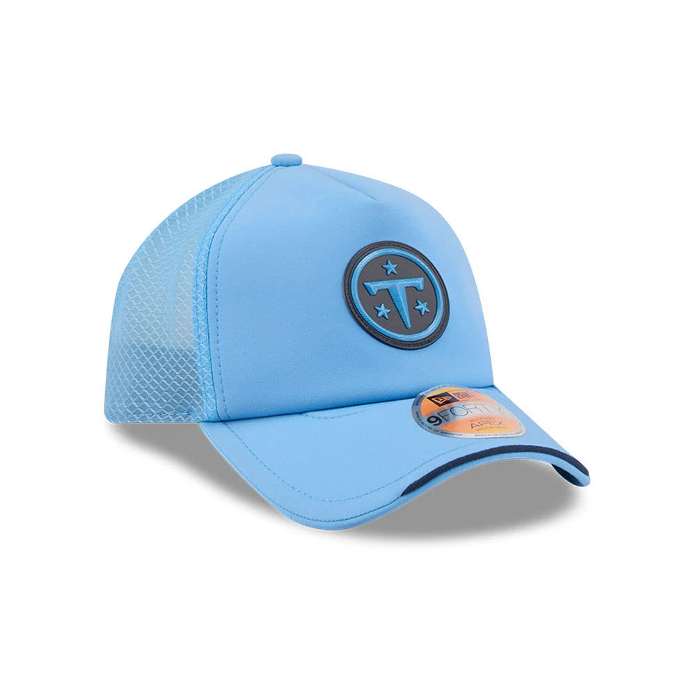 Tennessee Titans NFL Sideline 2026 Pastel Blue New Era 9FORTY Apex Adjustable Cap, three-quarter view showing a dark round embroidered logo on the front panel, a curved visor with black edging, and a 9FORTY size sticker on the visor.