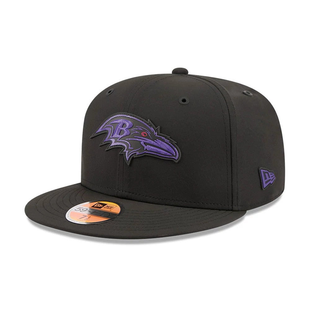 Baltimore Ravens NFL Sideline 2026 Black New Era 59FIFTY Fitted Cap, three-quarter view showing a purple and black embroidered Ravens logo on the front panel, black flat visor with a gold 59FIFTY size sticker, and New Era flag logo on the left side.