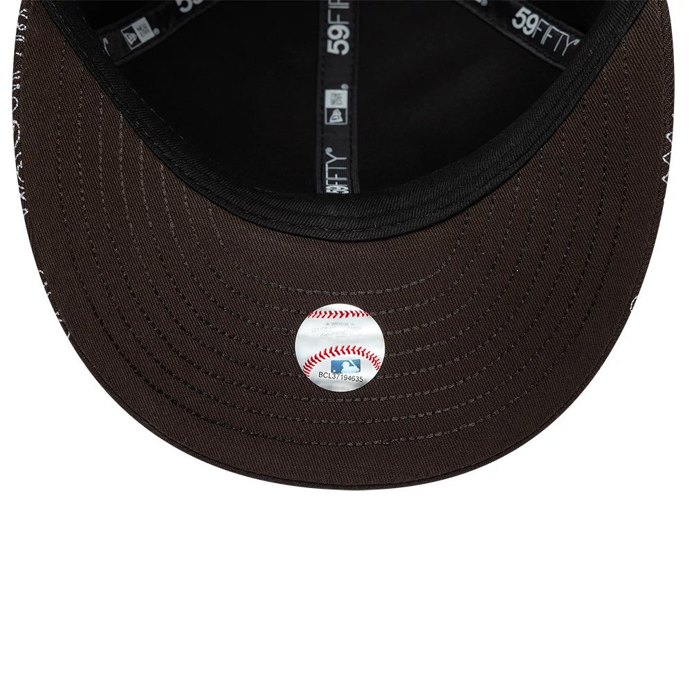 LA Dodgers MLB All Over Paisley Dark Brown New Era Low Profile 59FIFTY Fitted Cap, inside view showing the white MLB Batterman sticker on the brown undervisor, black sweatband, and black taping with white 59FIFTY branding.
