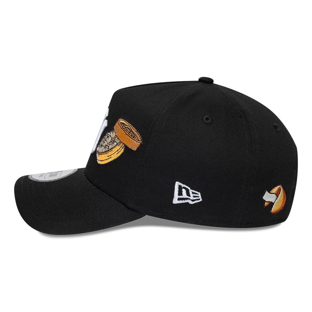 New York Yankees MLB Food Black New Era 9FORTY A-Frame Adjustable Cap, side view showing a dumpling embroidery on the mid-panel, a fortune cookie on the rear panel, and the New Era flag logo in white on the left side.