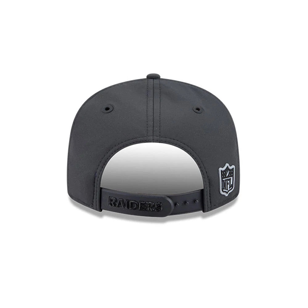 Raiders Youth NFL Sideline 2026 Charcoal New Era 9FIFTY Snapback Adjustable Cap, rear view showing the white embroidered NFL logo on the right back panel, a black Raiders wordmark on the adjustable snap closure, and charcoal crown with side eyelets.