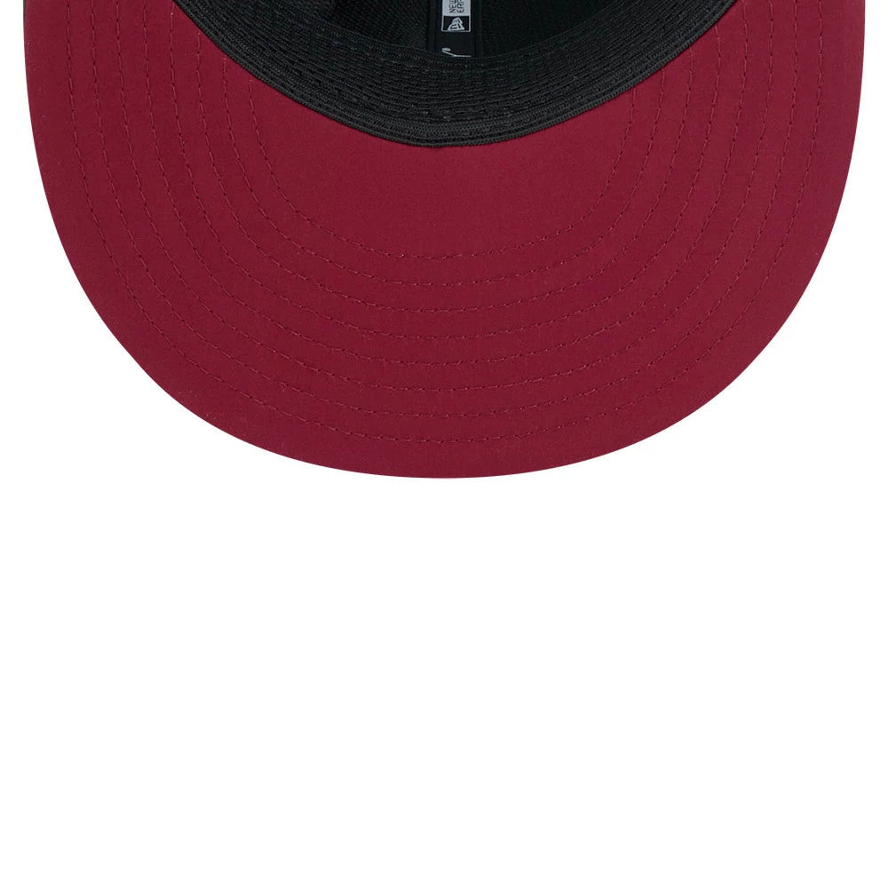 Commanders NFL Sideline 2026 Charcoal New Era 9FIFTY Snapback Adjustable Cap, inside view showing the black sweatband against the deep red undervisor, with black taping featuring the New Era logo and NFL branding.