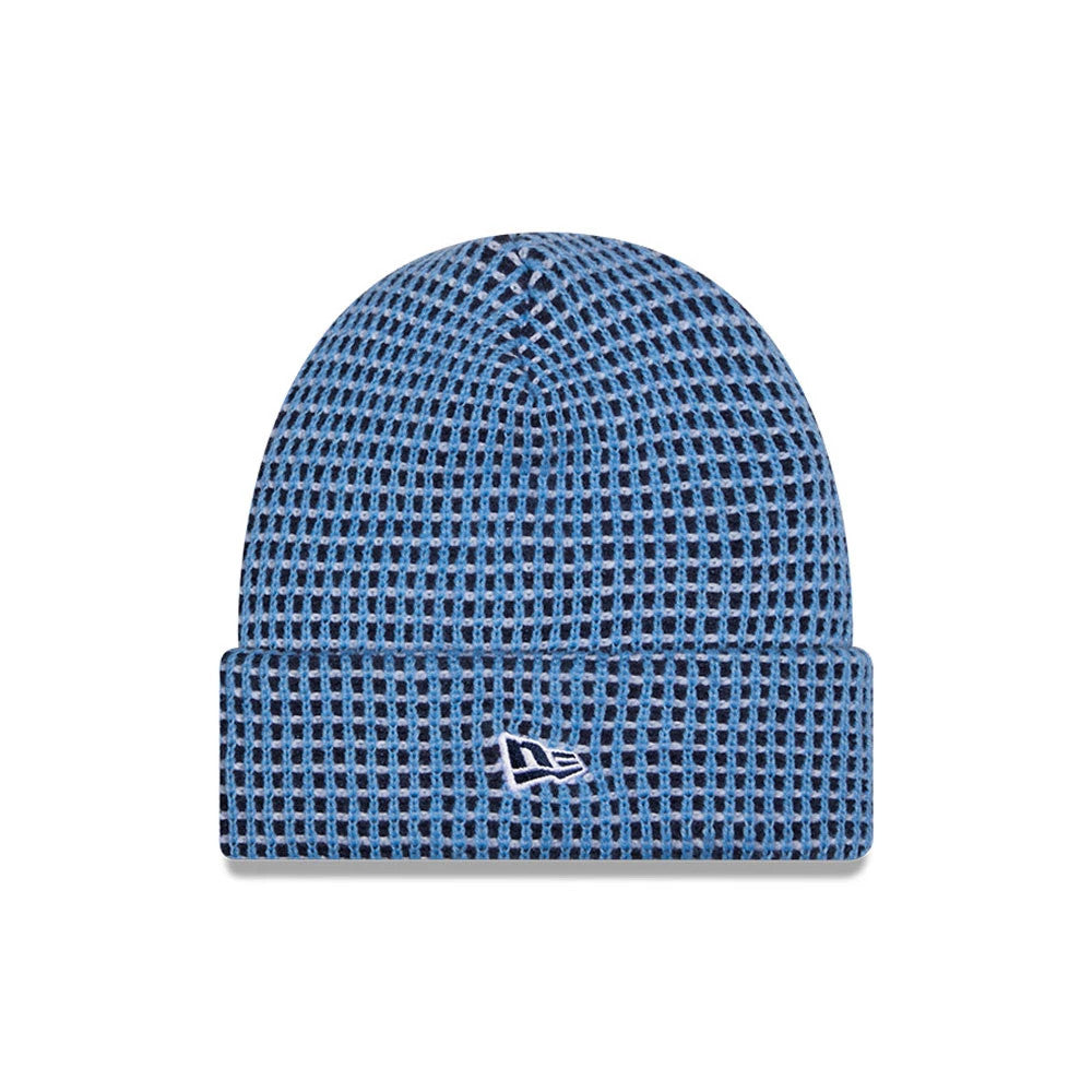 New Era Tennessee Titans NFL Sideline 2026 Blue & Black Cuff Knit Beanie Hat, front view showing a blue and black grid pattern on the knit fabric, with the white embroidered New Era flag logo on the folded cuff at the front.