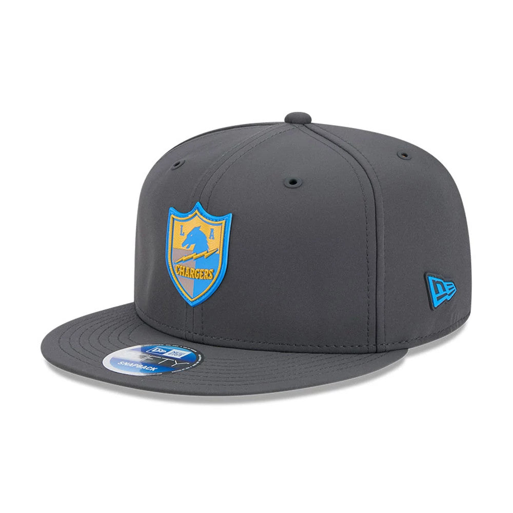 LA Chargers NFL Sideline 2026 Charcoal New Era 9FIFTY Snapback Adjustable Cap, three-quarter view showing the blue and gold team logo on the front panel, a flat charcoal visor with a Snapback sticker, and a blue New Era flag logo on the left side.