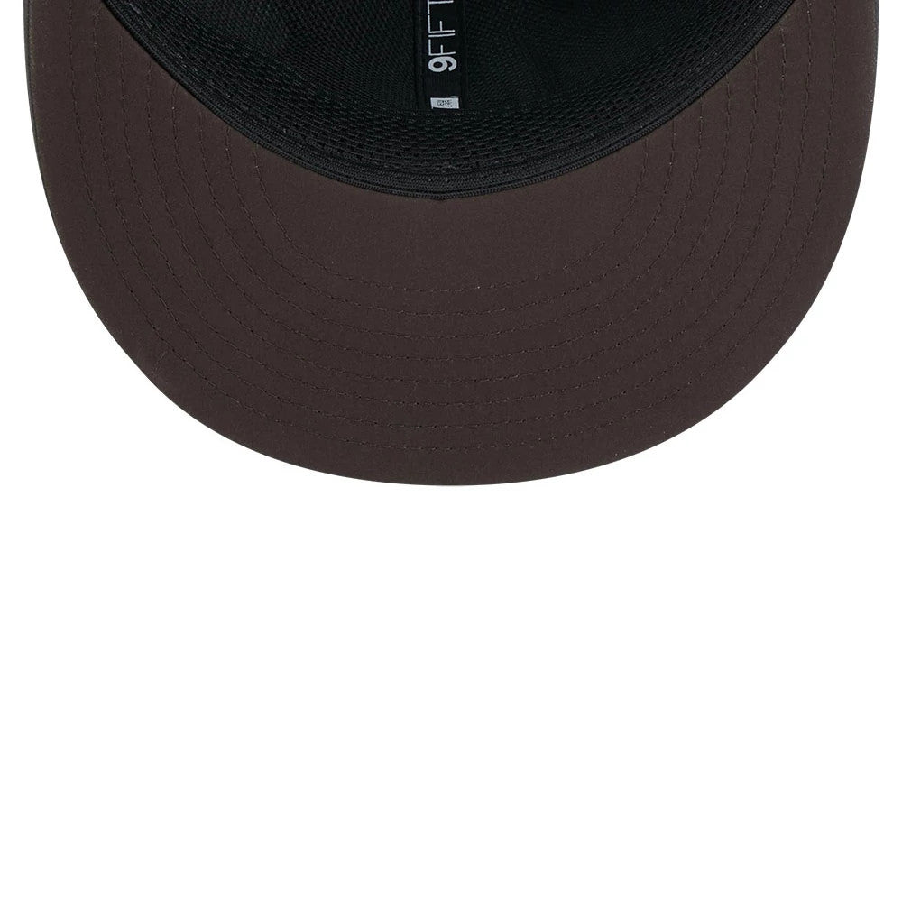 Browns NFL Sideline 2026 Charcoal New Era 9FIFTY Snapback Adjustable Cap, inside view showcasing a black sweatband against the dark charcoal undervisor, with a 9FIFTY design label along the inner band.