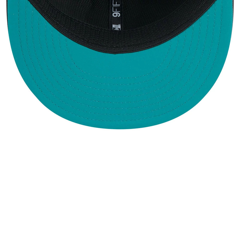 Miami Dolphins NFL Sideline 2026 Charcoal New Era 9FIFTY Snapback Adjustable Cap, inside view showing a teal undervisor, black taping with the 9FIFTY label, and a matching black sweatband for a clean finish.