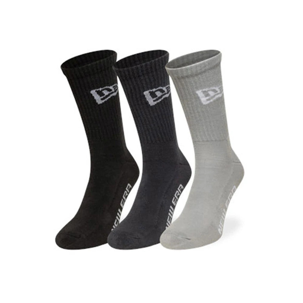 New Era Flag Grey 3 Pack Crew Socks, front view showing three pairs in black, dark grey, and light grey, each with a white embroidered New Era logo near the top and New Era lettering along the side of the foot.