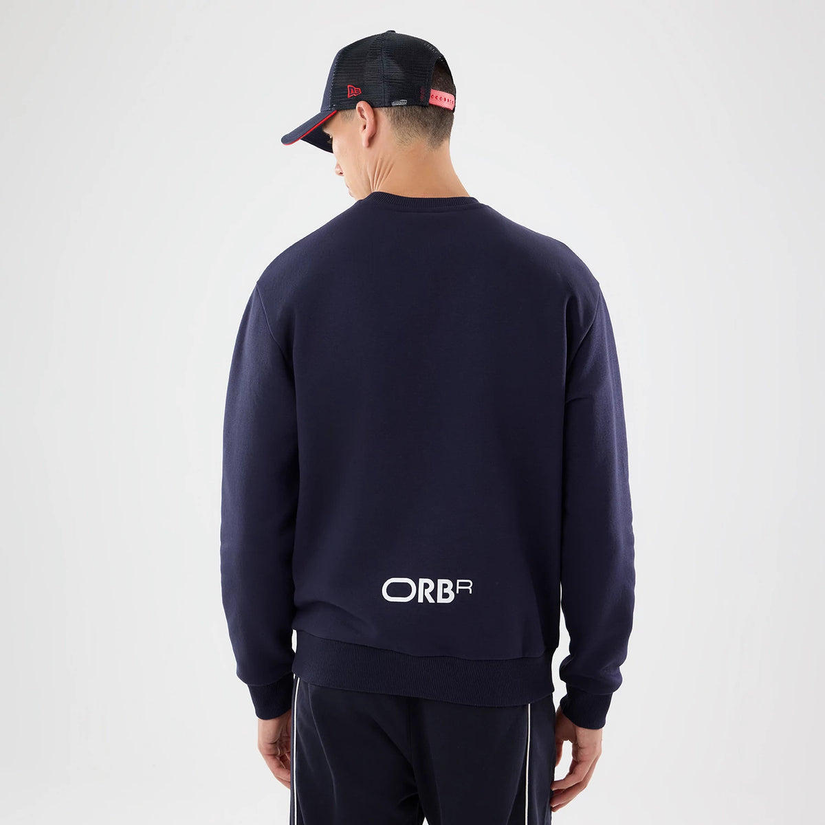 The model is wearing this Red Bull Racing Oversized Crew Neck Sweater in dark blue. 2