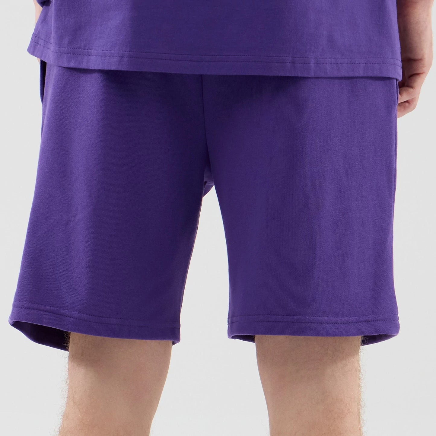 The model is wearing these NBA League Essential LA Lakers Oversized Shorts in purple. 7