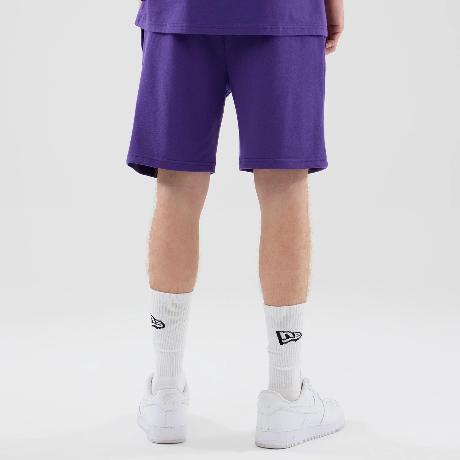 The model is wearing these NBA League Essential LA Lakers Oversized Shorts in purple. 2
