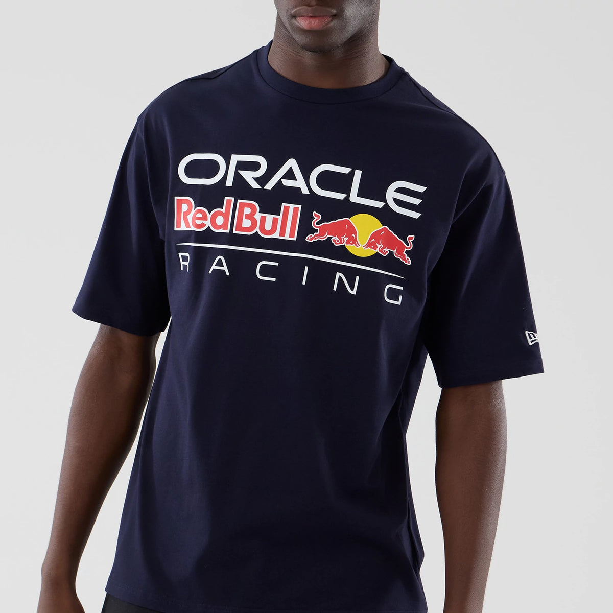 New Era Red Bull Racing Graphic Dark Blue Oversized T-Shirt, front view on-model showing Oracle Red Bull Racing lettering with the red bull and yellow sun graphic across the chest, and a small embroidered New Era logo on the sleeve.