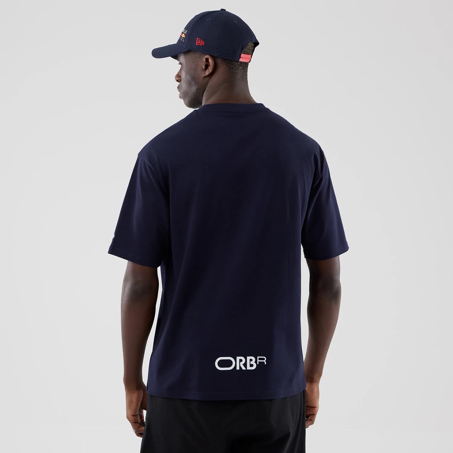 The model is wearing this Red Bull Racing Graphic Oversized T-Shirt in dark blue. 2