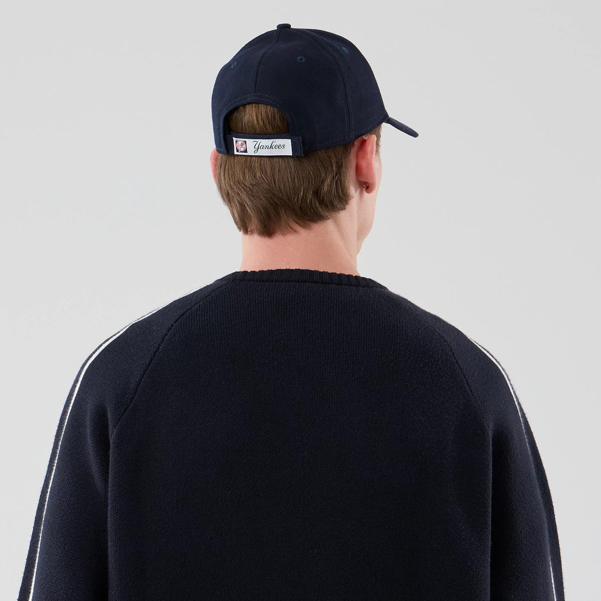The model is wearing this MLB Knit New York Yankees Knitted Sweater in navy. 7