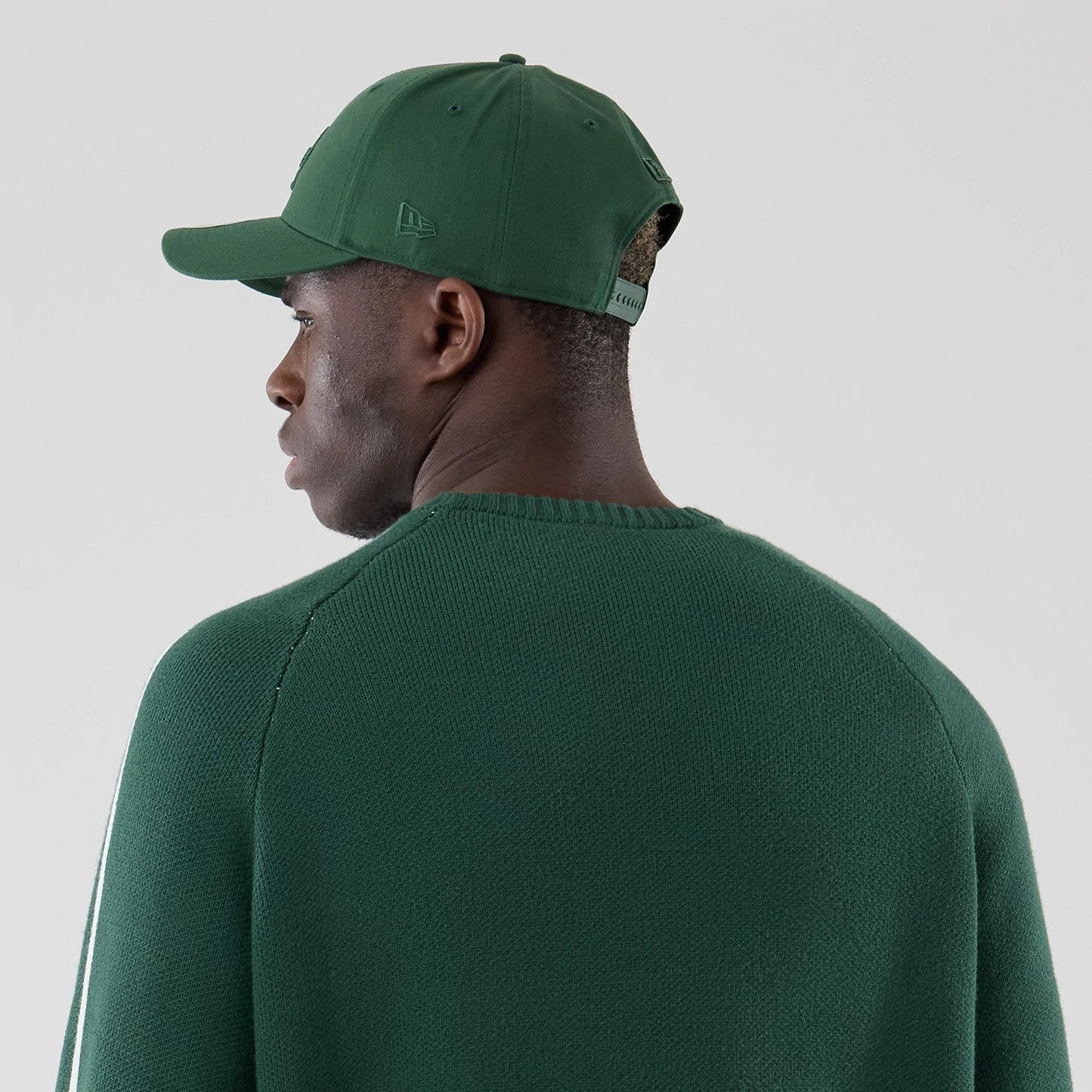 The model is wearing this MLB Knit LA Dodgers Knitted Sweater in dark green. 7