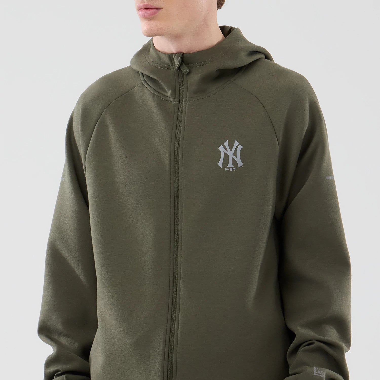 New Era New York Yankees MLB Core Plus Green Full Zip Hoodie, front view showing the zip closure down the centre, a grey embroidered New York Yankees logo on the left chest, and a hooded design with long sleeves extending to the wrists.