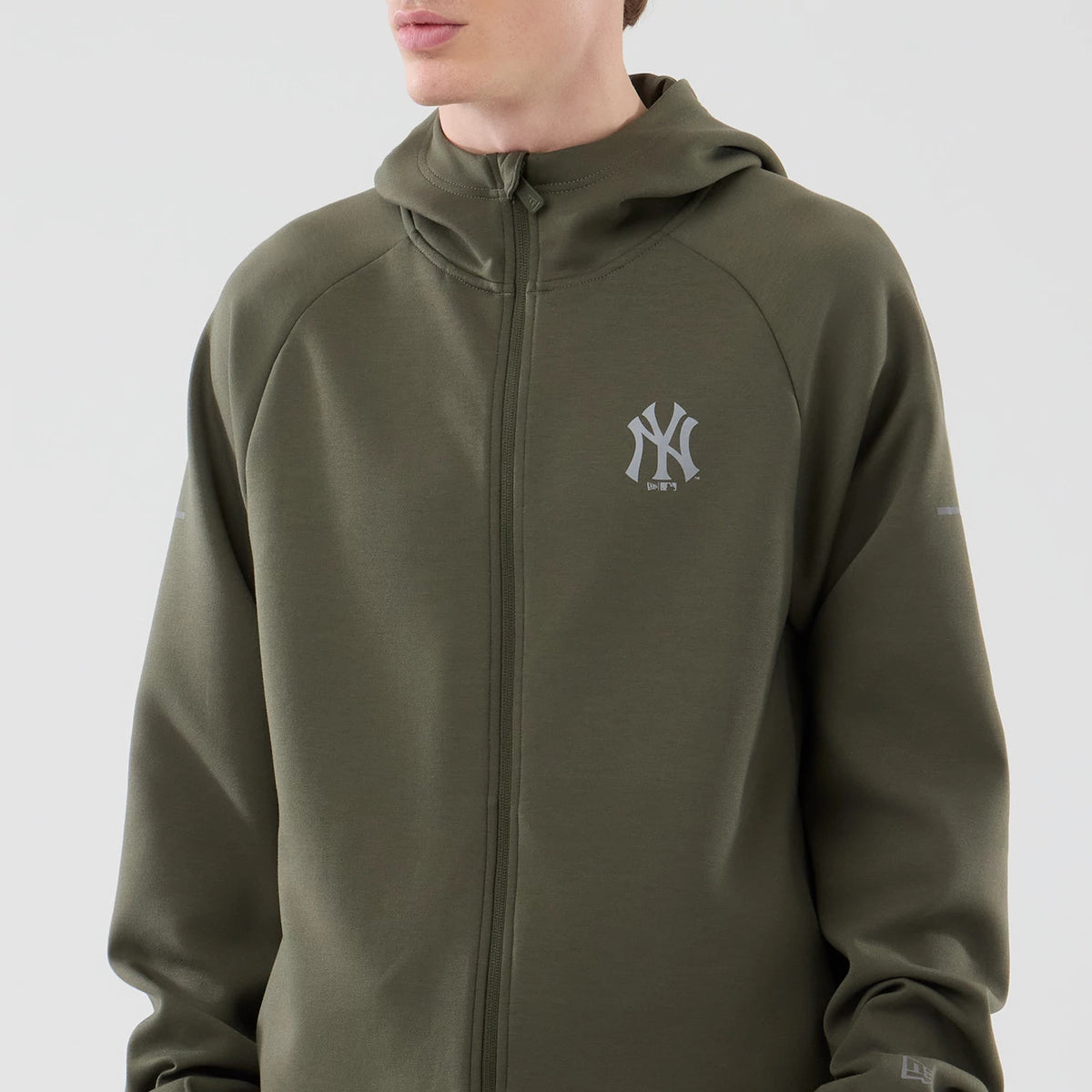 New Era New York Yankees MLB Core Plus Green Full Zip Hoodie, front view showing the zip closure down the centre, a grey embroidered New York Yankees logo on the left chest, and a hooded design with long sleeves extending to the wrists.