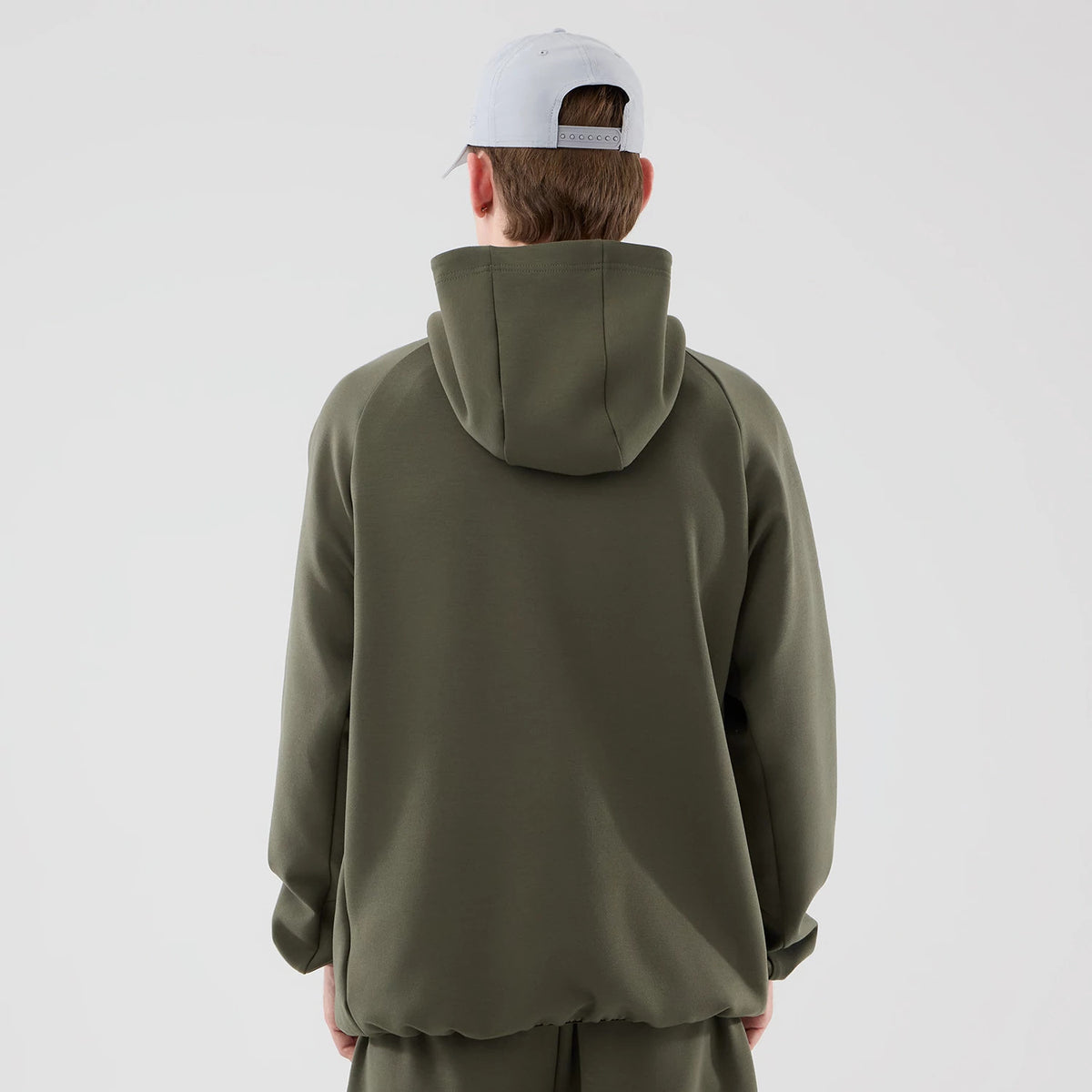 New Era New York Yankees MLB Core Plus Green Full Zip Hoodie, back view showing a plain green back with a large hood at the top, raglan sleeves offering casual styling, and a model wearing a light grey cap completing the ensemble.