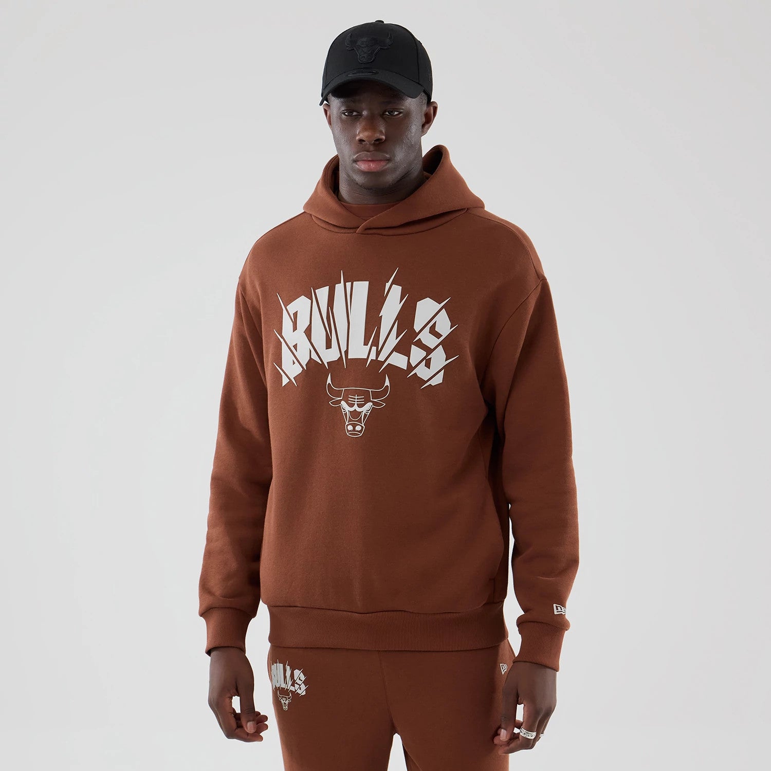 The model is wearing this NBA Core Plus Chicago Bulls Pullover Hoodie in brown. 1