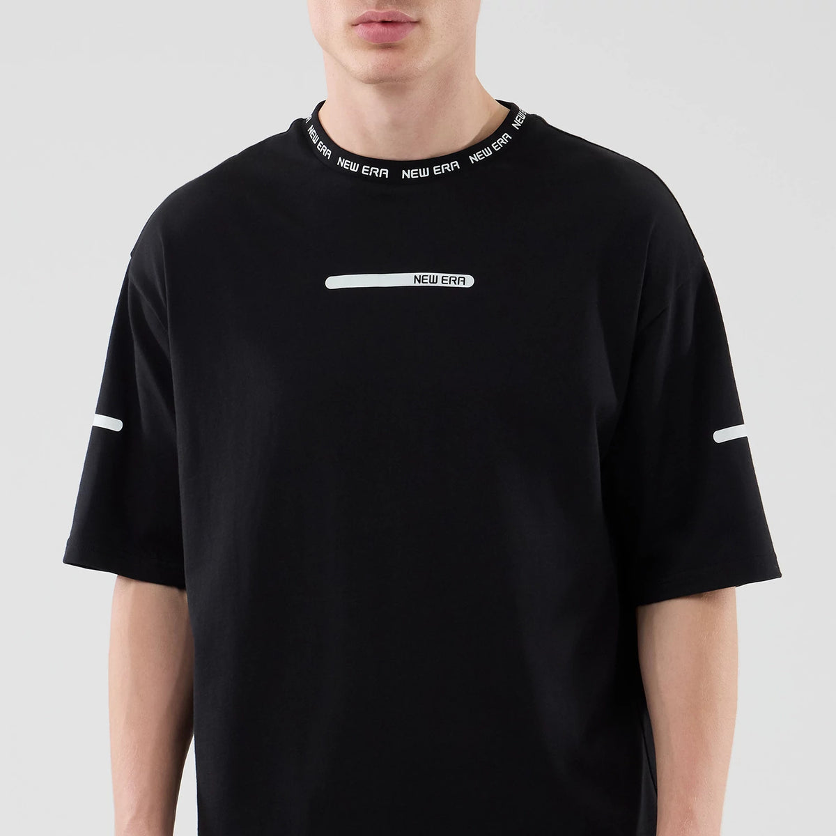 New Era Tech Black T-Shirt, front view displaying the white New Era logo printed on the chest, distinctive New Era lettering around the black ribbed collar, and minimalistic white stripe details on both sleeves of the black t-shirt.