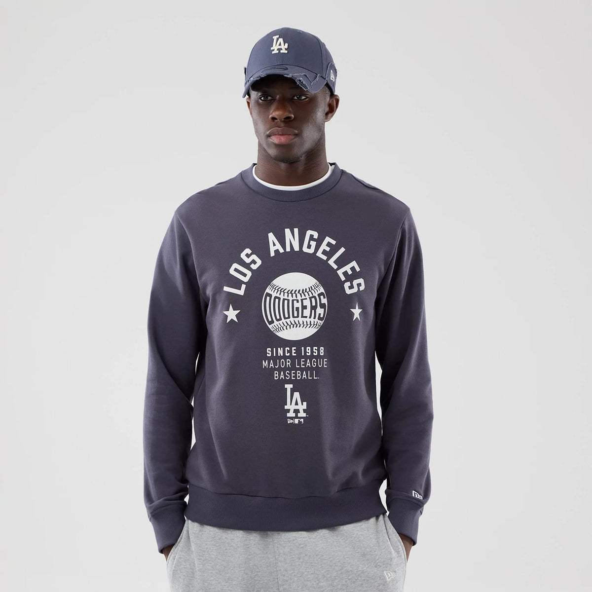 The model is wearing this MLB Graphic LA Dodgers Oversized Crew Neck Sweater in grey. 3