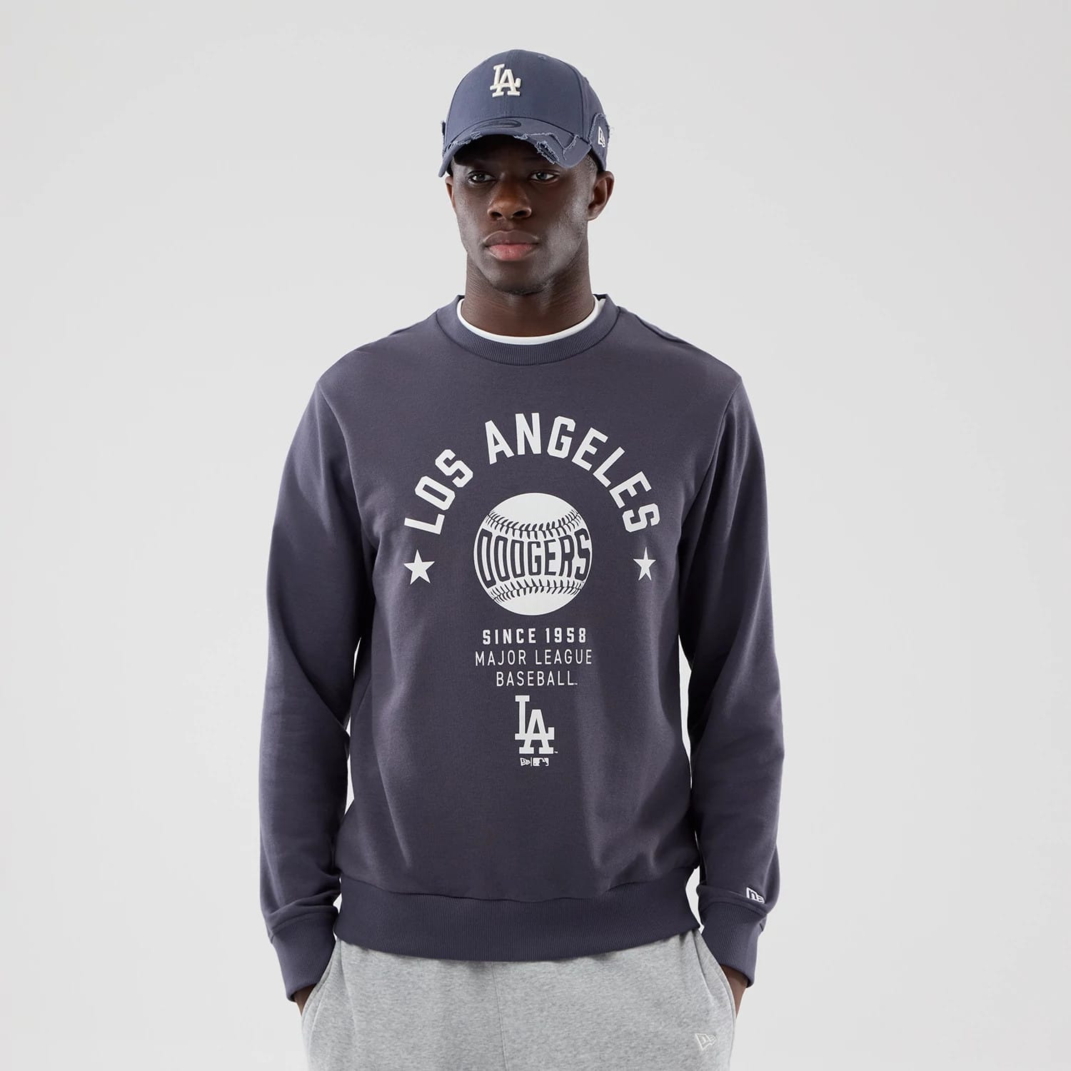 The model is wearing this MLB Graphic LA Dodgers Oversized Crew Neck Sweater in grey. 3