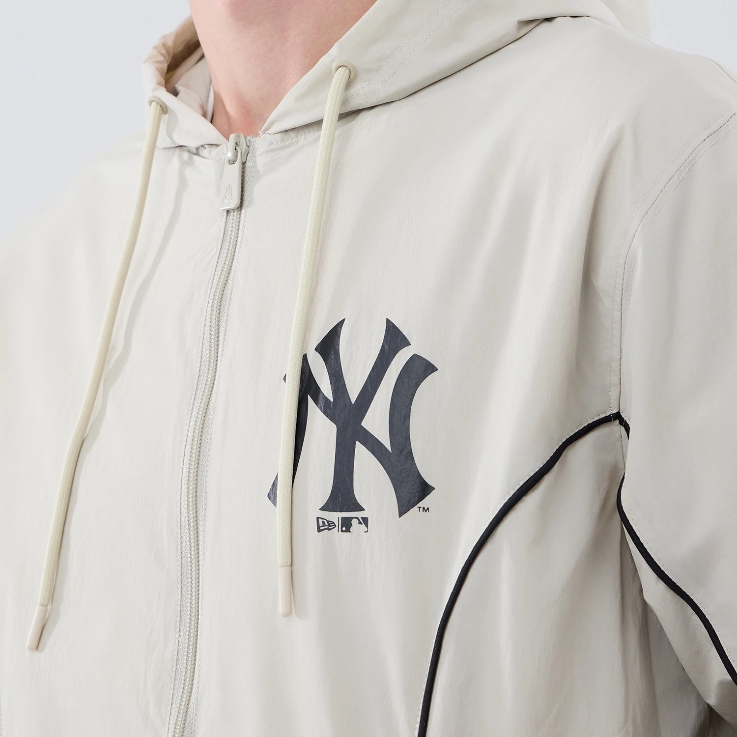 The model is wearing this MLB Piping New York Yankees Jacket in cream. 4