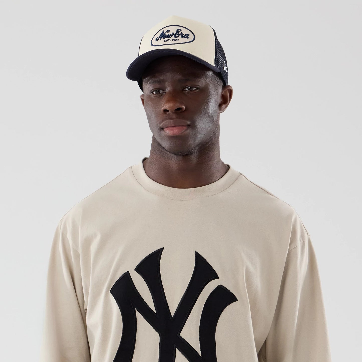 The model is wearing this MLB New York Yankees Oversized Long Sleeve T-Shirt in light beige. 7