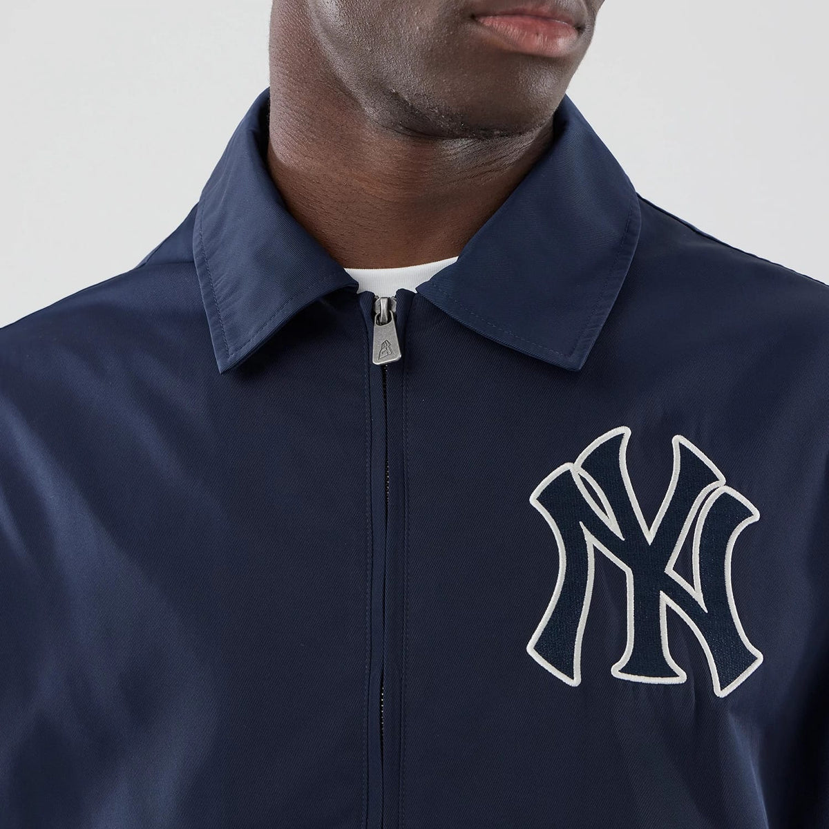 The model is wearing this MLB Collared New York Yankees Jacket in navy. 4