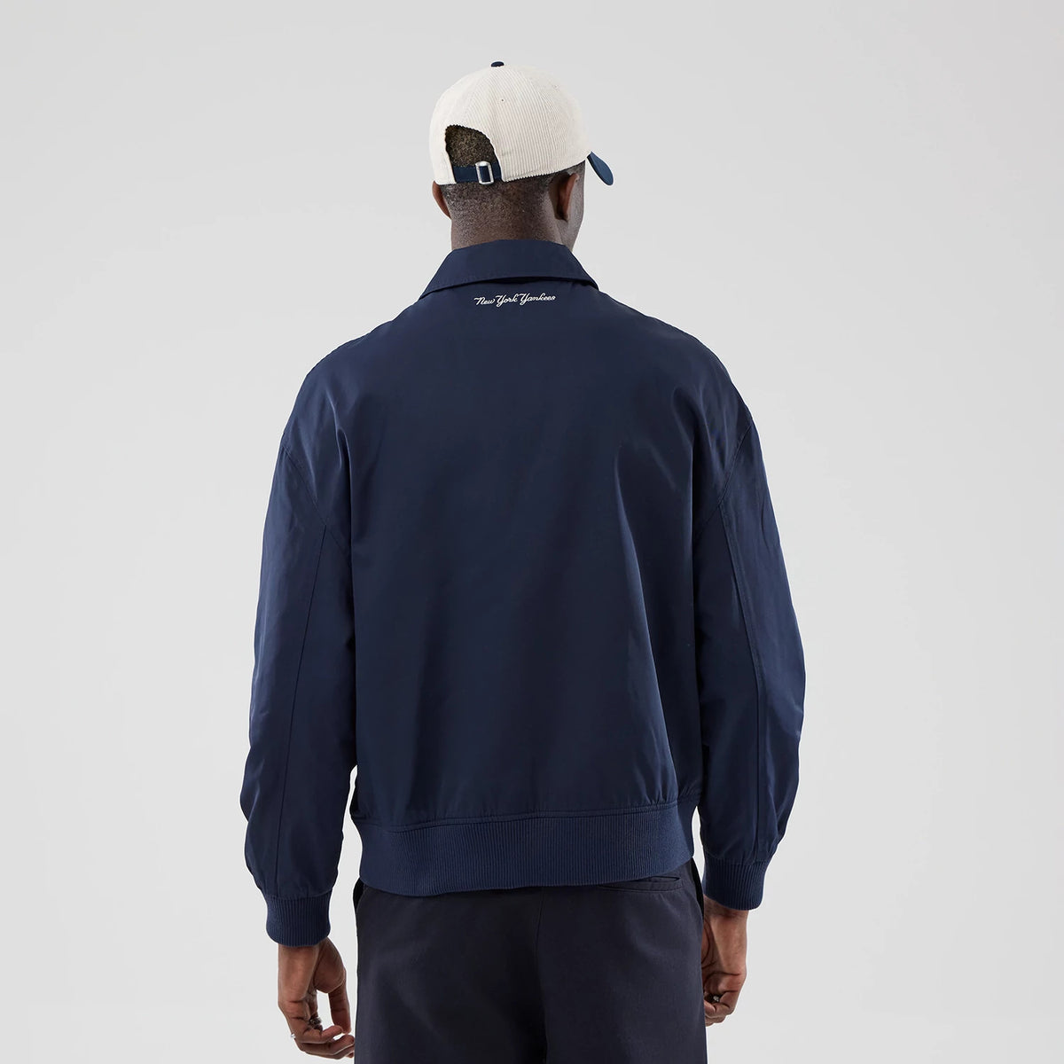 The model is wearing this MLB Collared New York Yankees Jacket in navy. 2