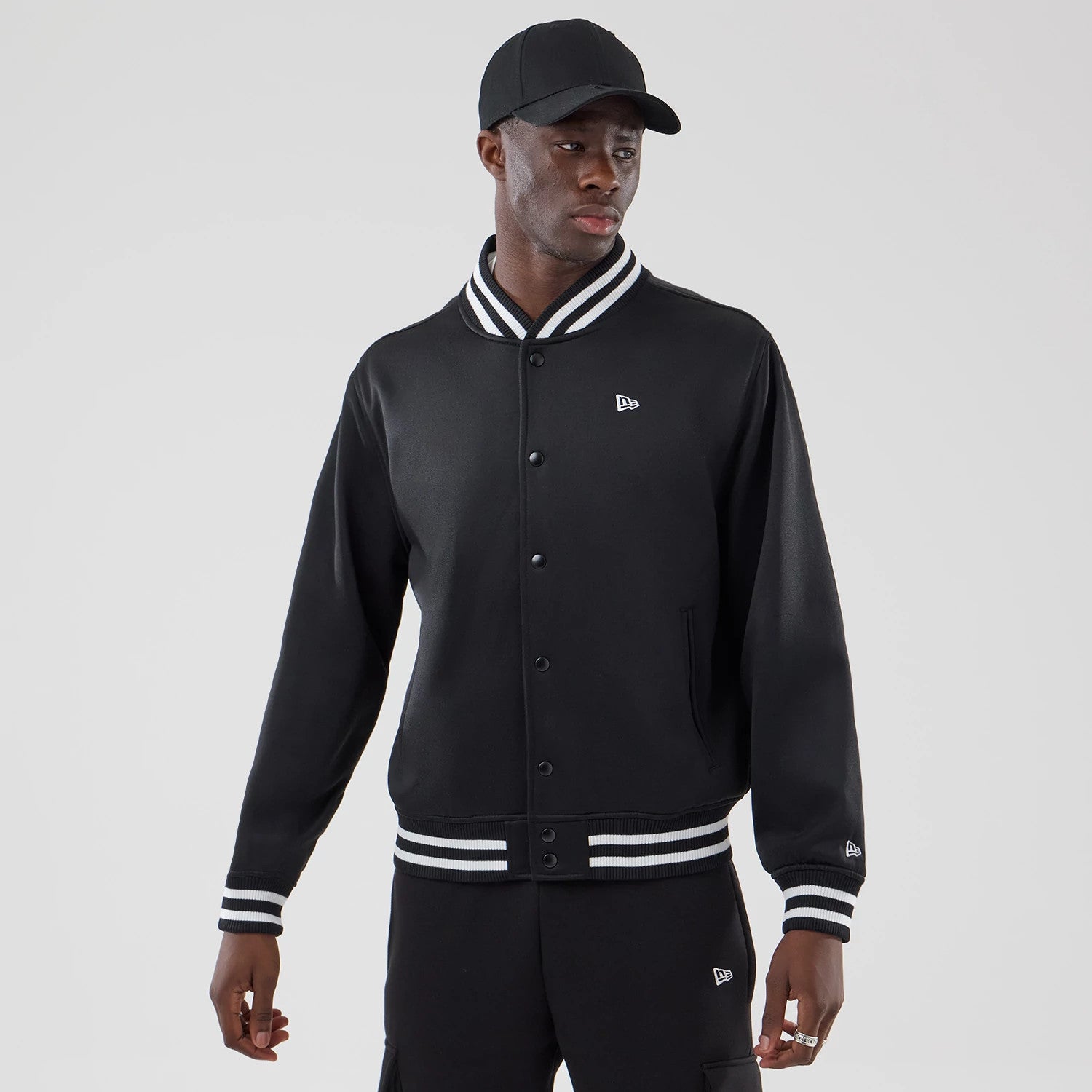 The model is wearing this New Era Jersey Bomber Jacket in black. 1